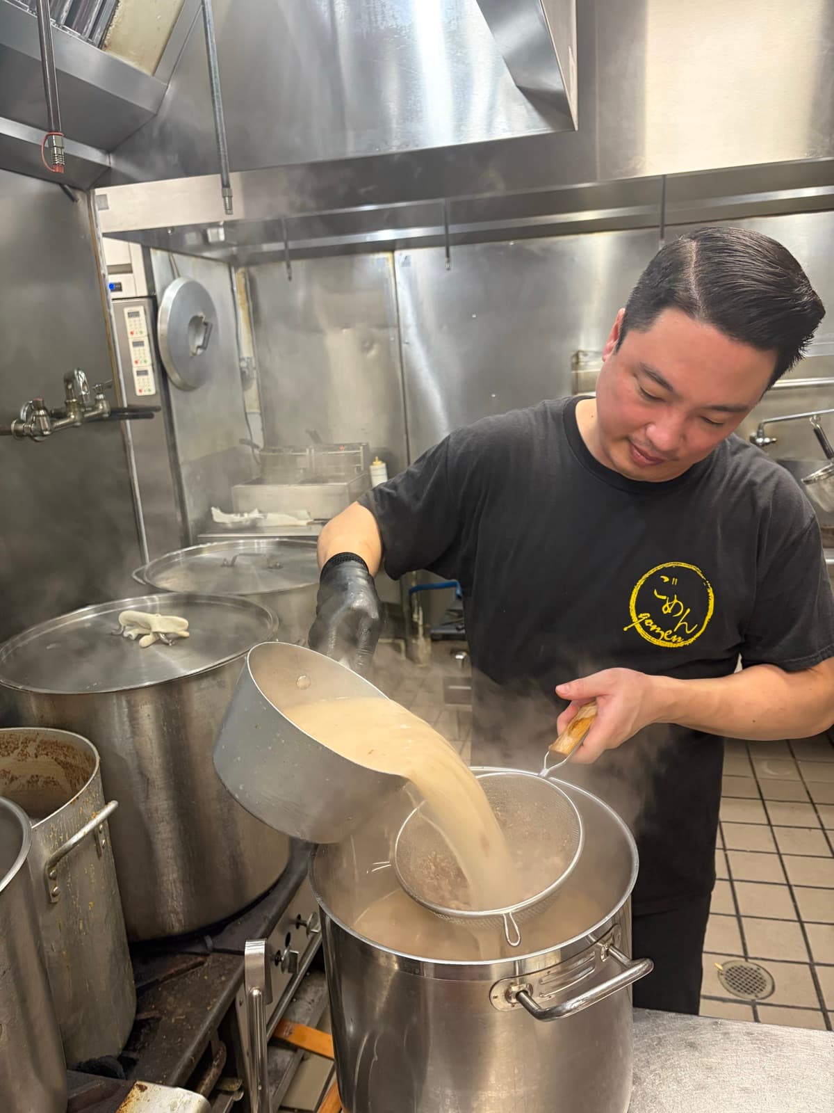 Pouring broth through a strainer into a stockpot, Gomen Ramen kitchen, Stanton