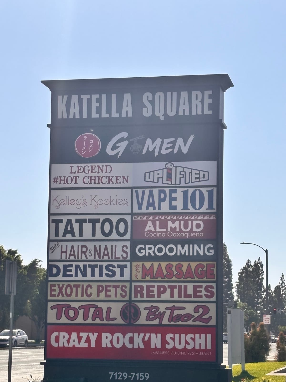 Katella Square plaza pylon sign with the red enso Gomen Ramen logo at the top